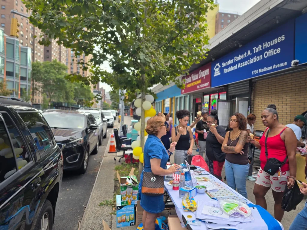 Maribel from Preferred Pharmacy speaking with residents at the Taft Resident Association gathering in East Harlem