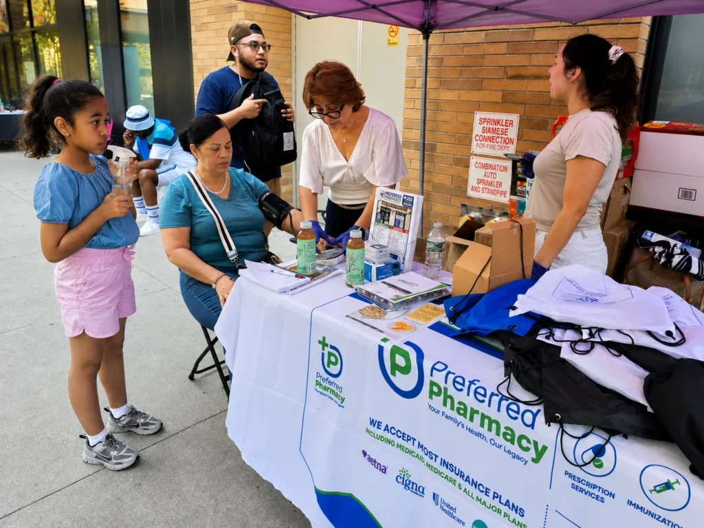Preferred Pharmacy team providing a blood pressure check at Taft Resident Association Family Day in East Harlem