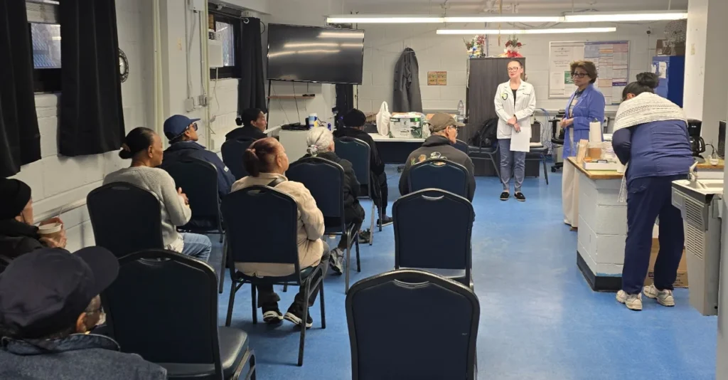 Anna Kelmenson, PharmD, Supervising Pharmacist at Preferred Pharmacy, speaking with older adults during a Taft NORC health education presentation in East Harlem